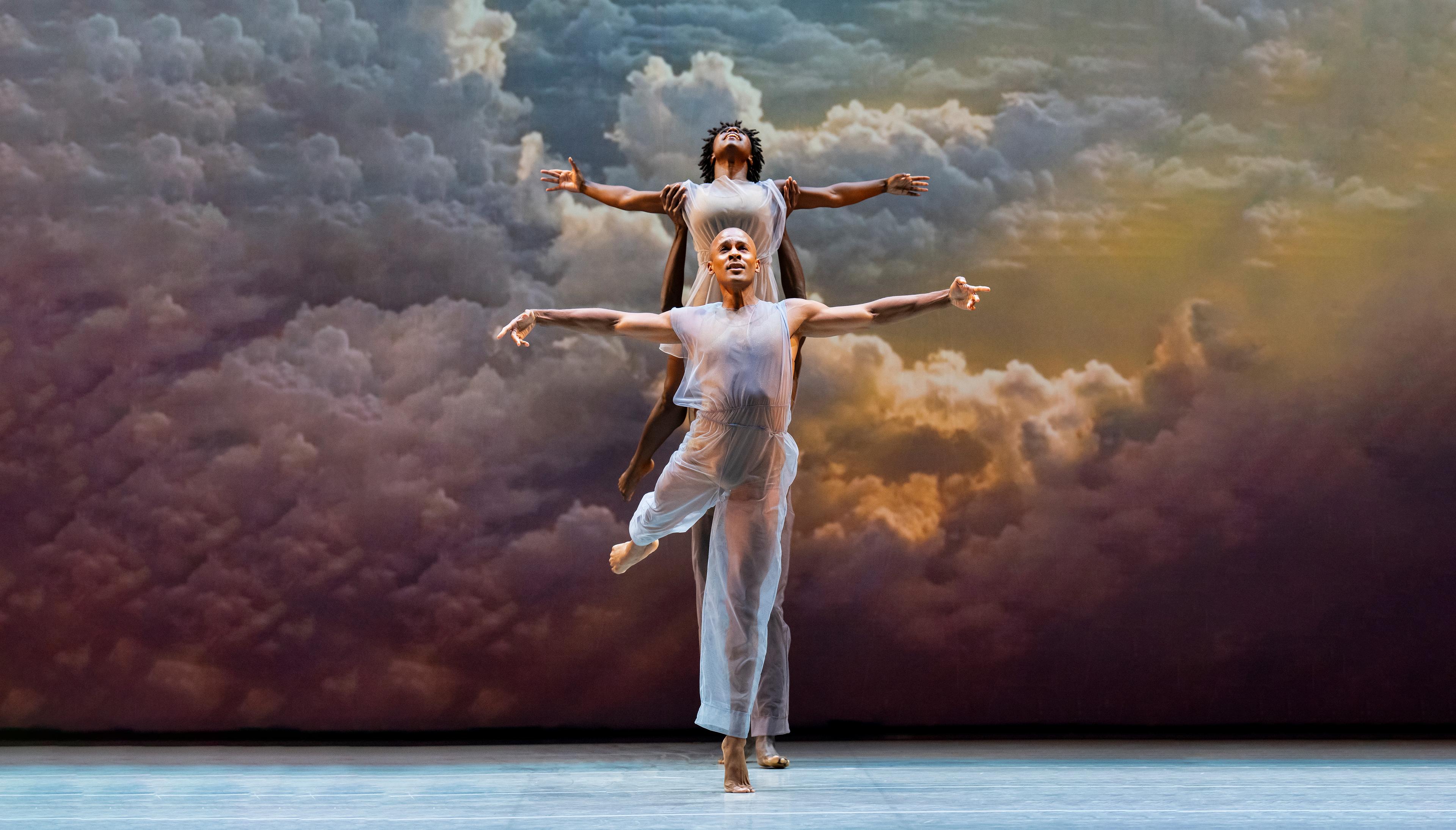 Yannick Lebrun and Ashley Green with arms extended outward in the shape of a cross in Lar Lubovitch's 'Many Angels'.