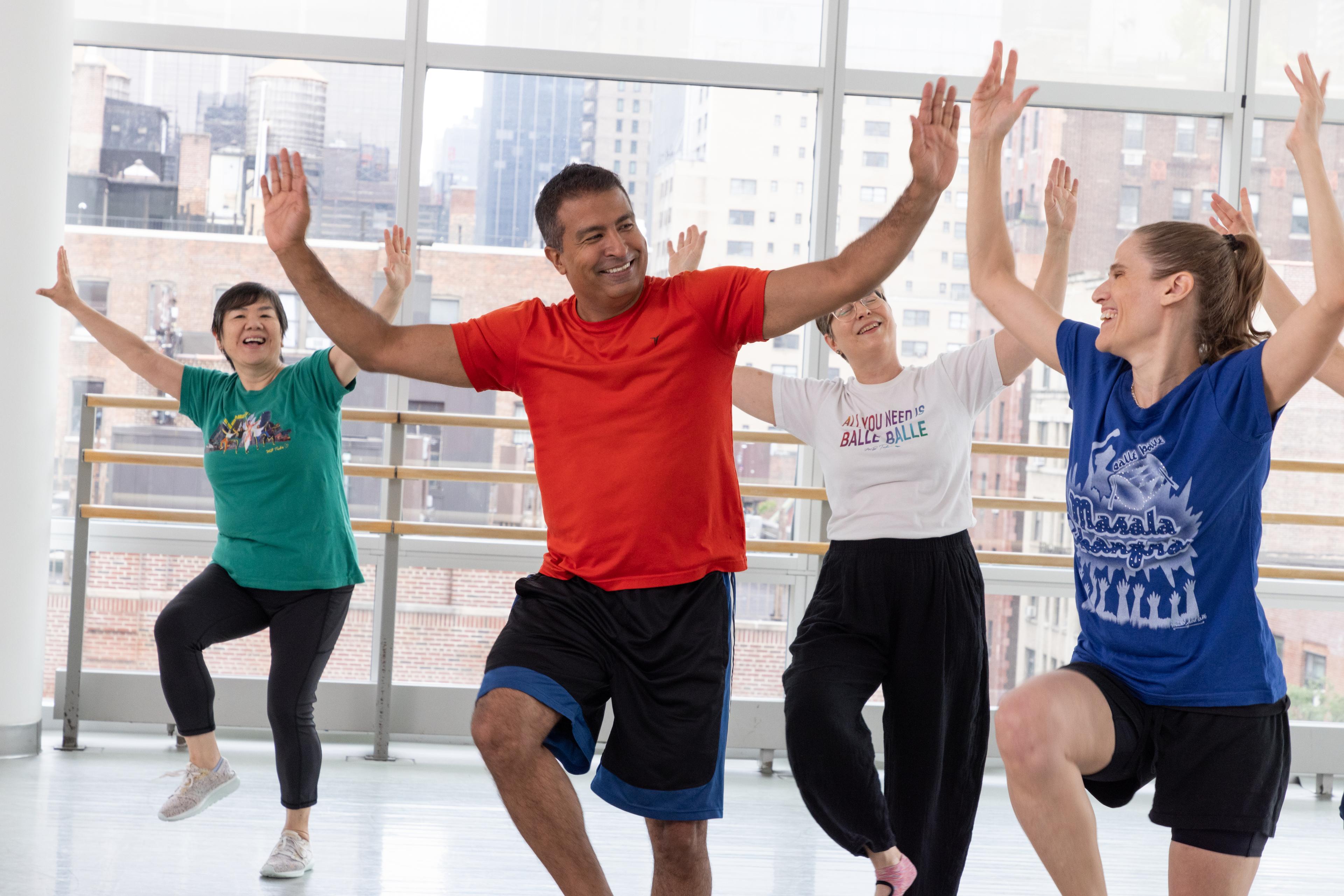 Masala Bhangra® ambassador Rizwan Dhanidina smiling and dancing with students at the Ailey Studios