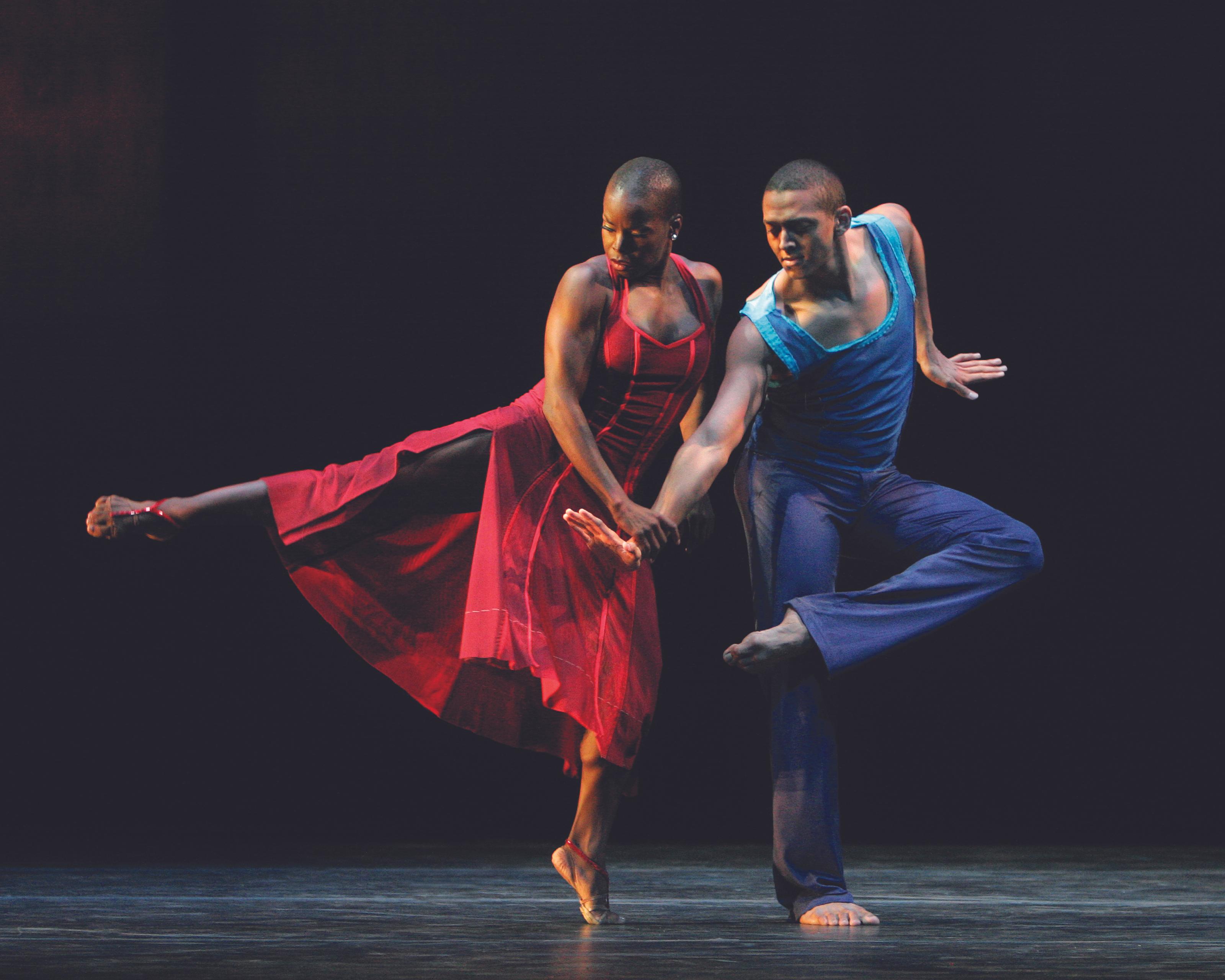 Former Ailey dancers Hope Boykin and Clifton Brown dancing in Judith Jamison's duet, 'A Case of You.' Boykin danced in a red dress with one leg in arabesque, holding onto Brown's arm.