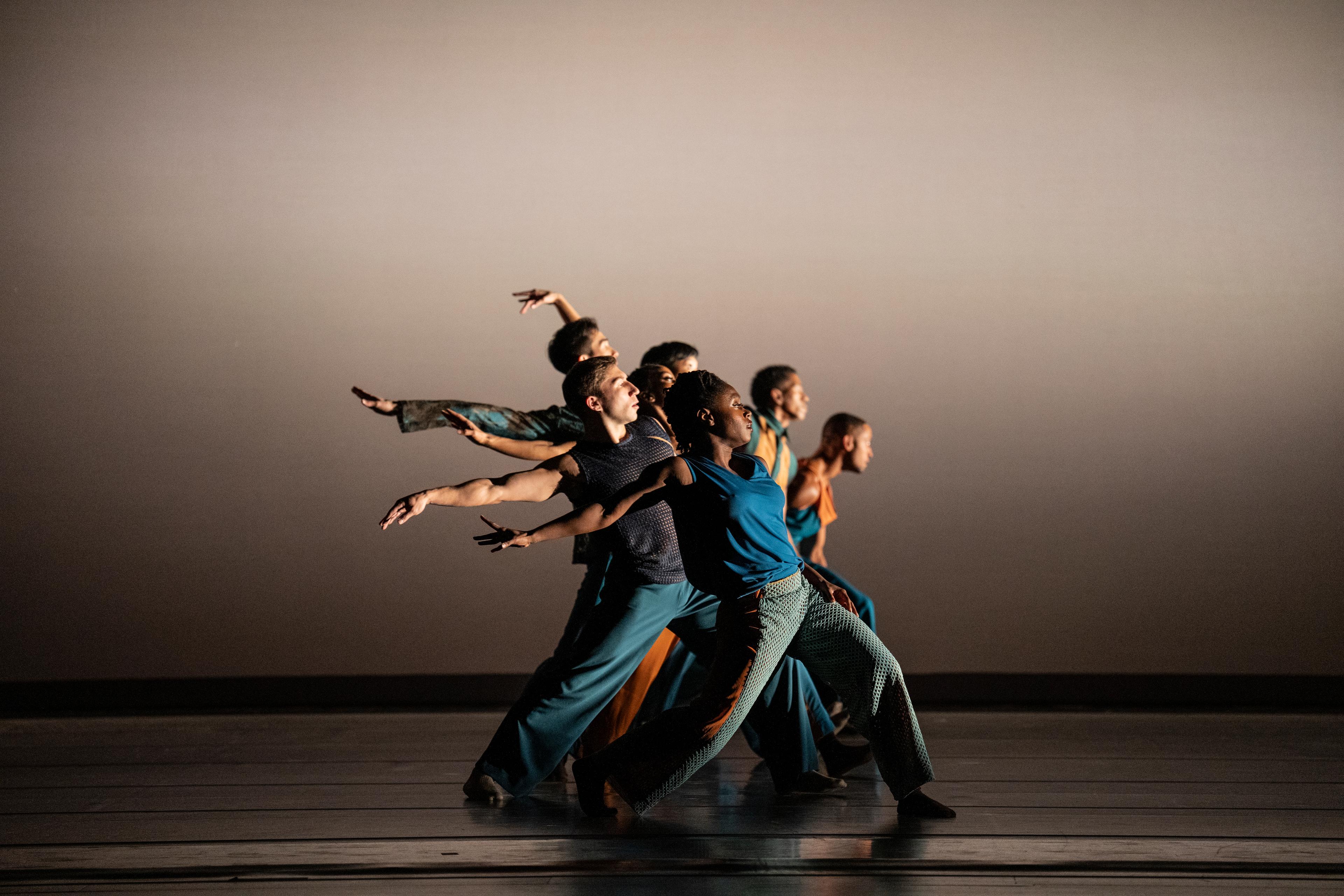 Group of dancers with arm extended to the side