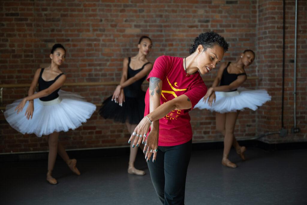 DTH School Director Tai Jimenez leading ballet class with students in tutus