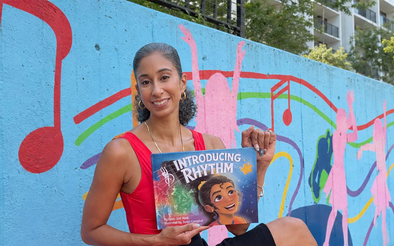 Alicia Graf Mack holding her book 'Introducing Rhythm'
