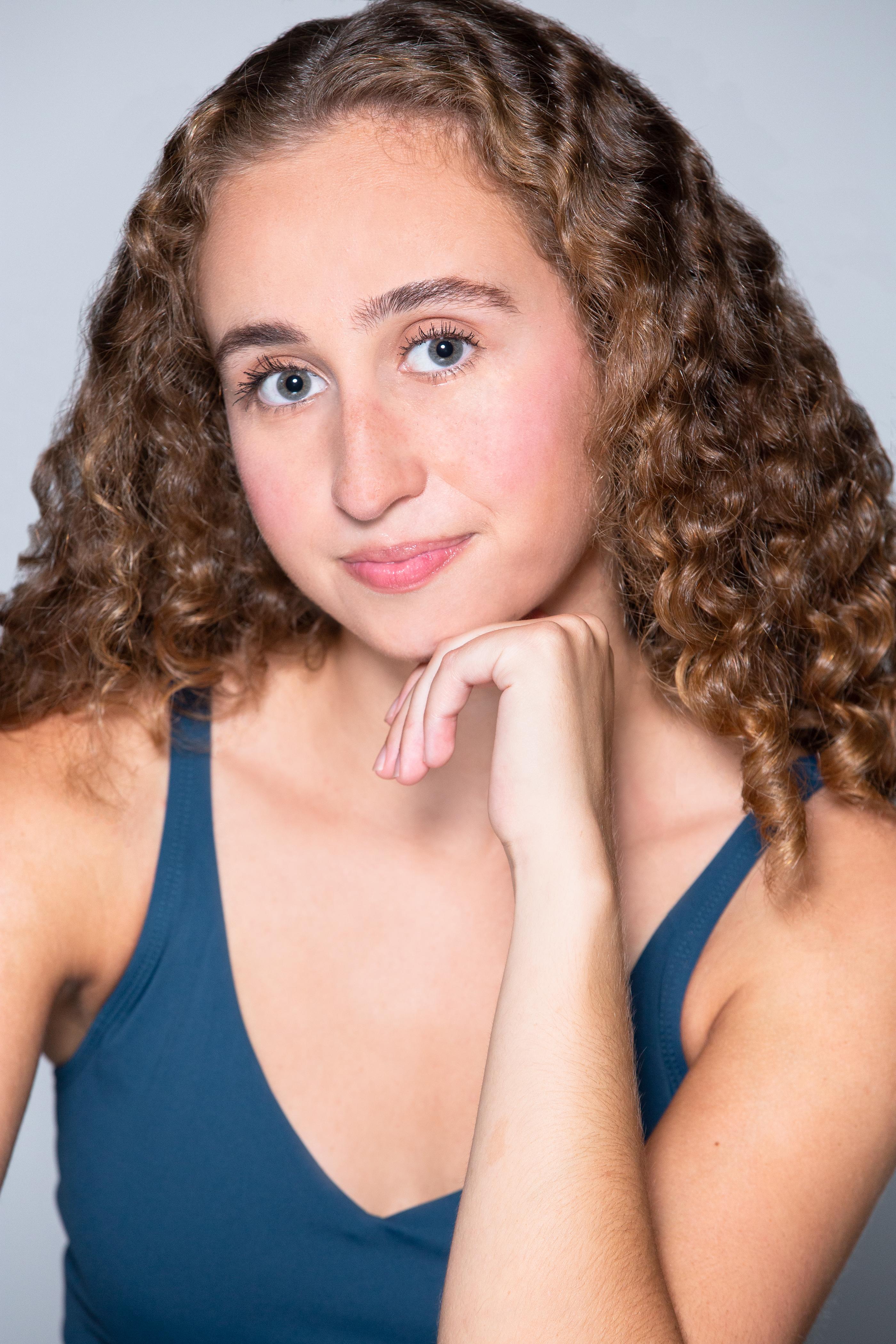 Headshot of Alexandra Love Strouse in a blue tank top