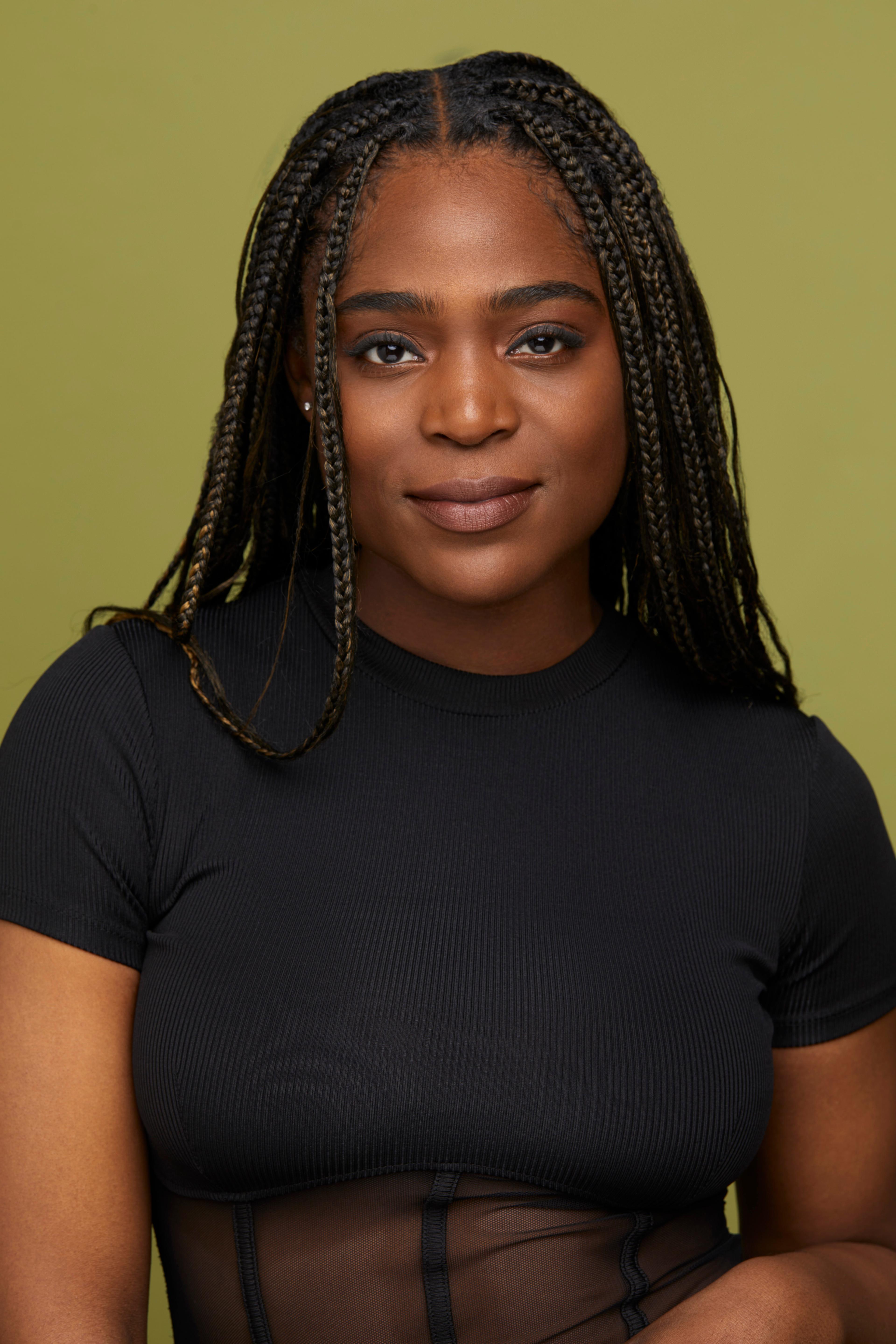 Amy Mitchell's headshot on a green background