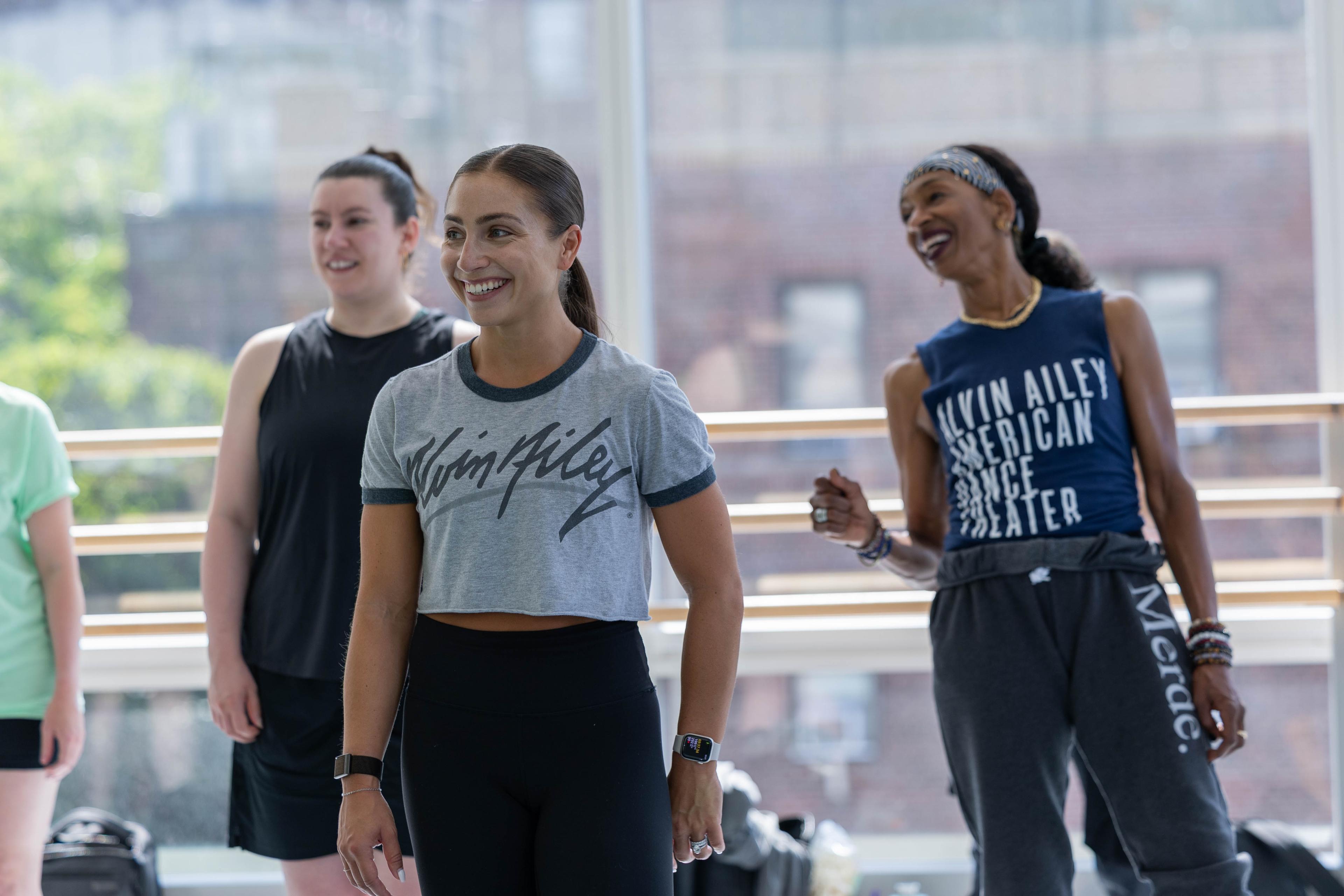 Participants in the Ailey Teacher Certification Program standing together during a workshop, smiling