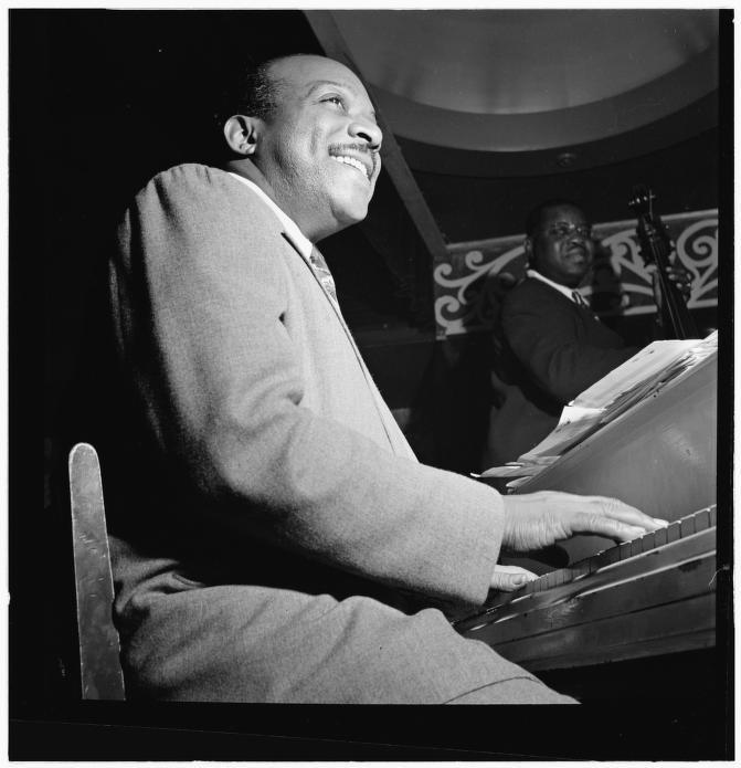 Black and white photo of Count Basie sitting at the piano at Aquarium