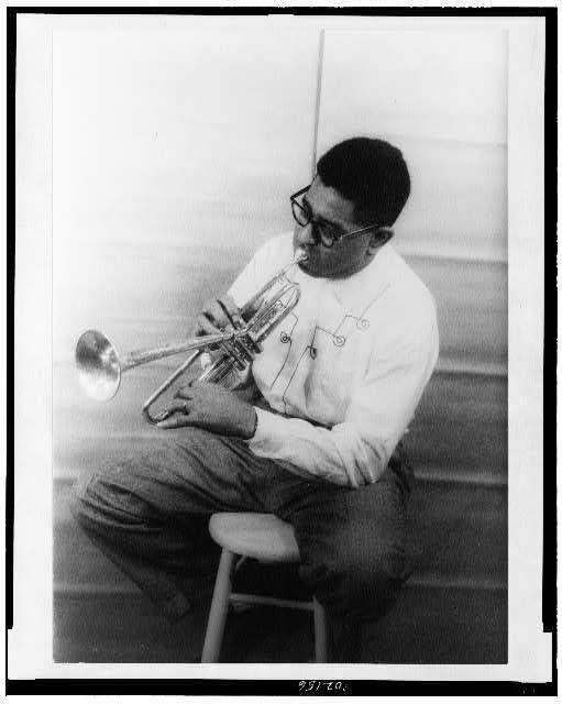 Black and white photo of Dizzy Gillespie holding his trumpet