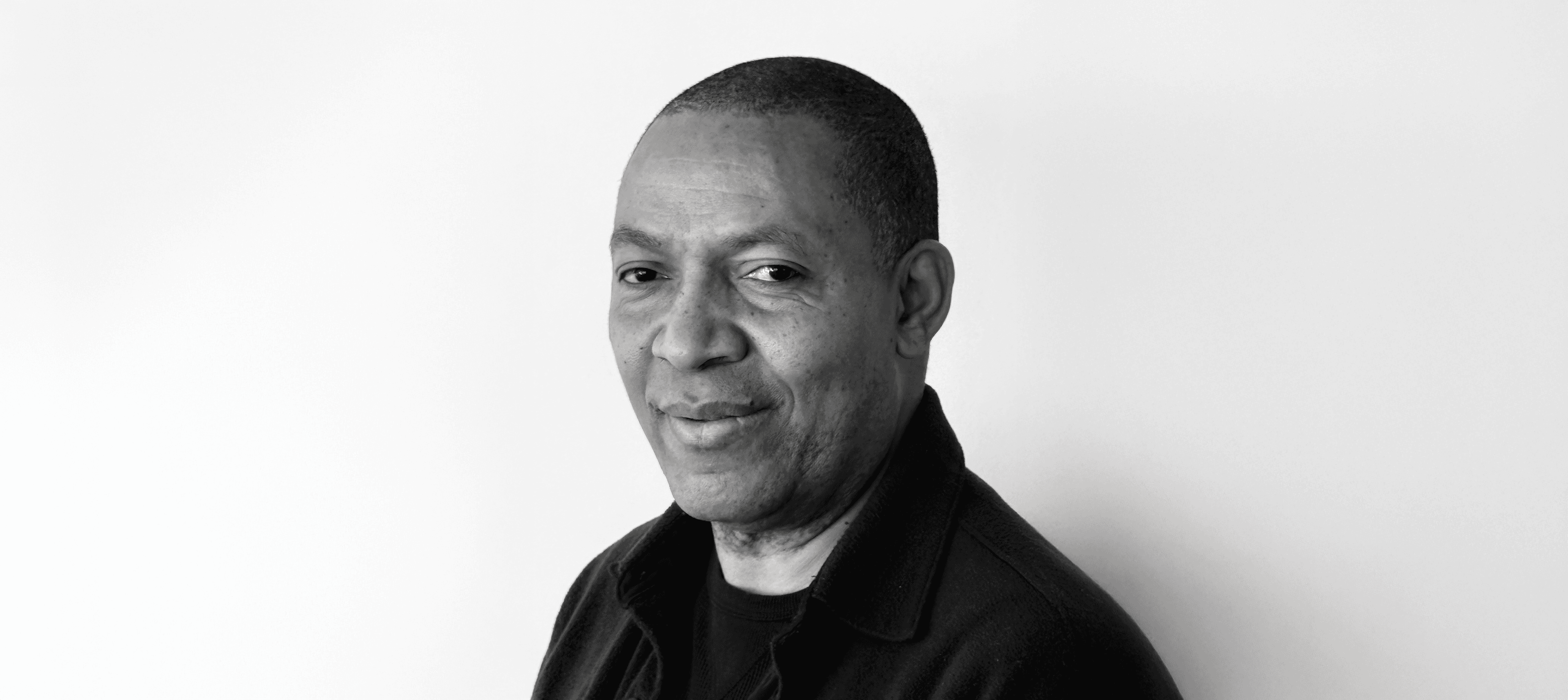 Julio Jean headshot in black and white