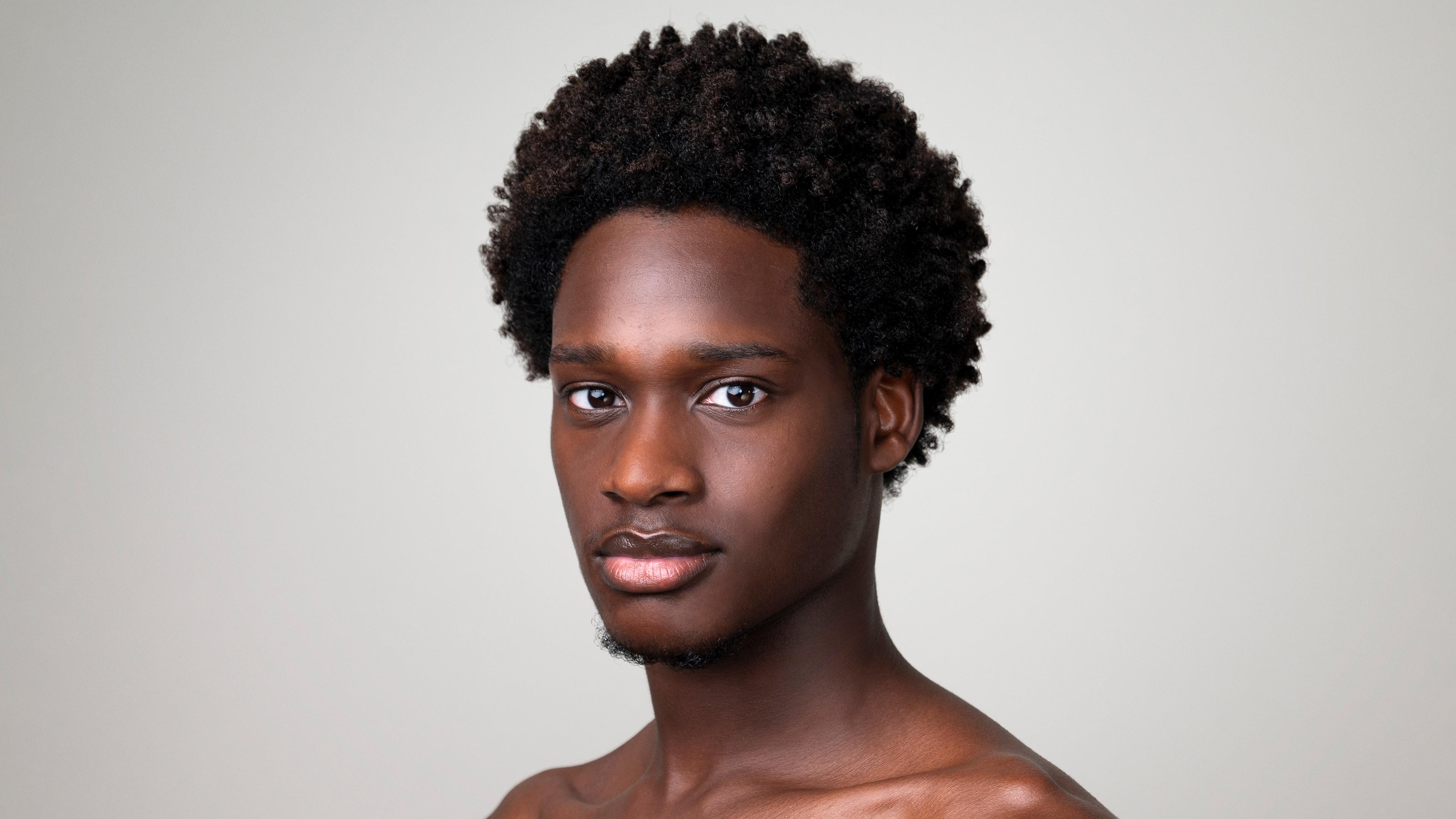 A headshot of Kamani Abu
